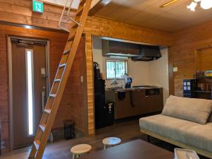 a living room with a ladder leading to a kitchen at Ashel Nasu in Nasu