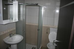 a bathroom with a sink and a toilet and a shower at Villa Zora in Star Dojran +13 photos