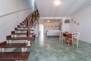 a living room with a staircase and a dining room at La Casetta di Cicci in Putifigari