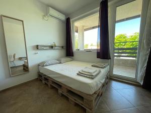 A bed or beds in a room at Caprice Apartment in Lozenec