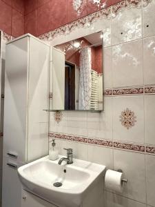 un baño con lavabo y espejo en W Sercu Gdańska, en Gdansk 10 fotos más