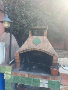 an outdoor brick oven with a light on top of it at Belle villa avec piscine proche monaco in La Turbie