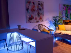 a living room with a purple table and chairs at Die Art Farm I Group Rental near Frankfurt I Messe in Schoneck +40 photos