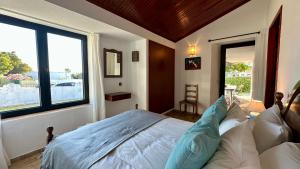 a bedroom with a bed and a large window at Gemini by Check-in Portugal in Albufeira