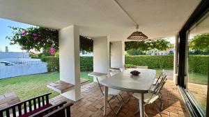 a patio with a table and chairs on a patio at Gemini by Check-in Portugal in Albufeira