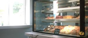 a display window of a bakery with different types of pastries at Grand Central Hotel in Ó Méith