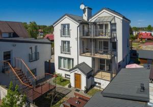 an aerial view of a white house with balconies at Villa MB in Augustów