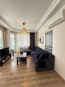 a living room with a couch and a table at Seaview 2BR 2BA Apartment in Antalya Lara Cliffs in Antalya