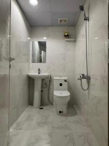 a bathroom with a toilet and a sink and a shower at Capital View in Abu Dhabi +46 photos