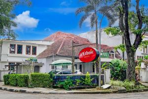 a red sign in front of a house at Dancenter The Ethnic Hotel in Bandung