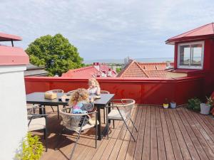 two children sitting at tables on a deck at Space - Style - Prime location - Old Town views in Tallinn