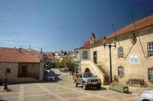 a truck parked in a parking lot next to a building at Douro 3 Bedrooms Magic Mountain Landscape in Vila Flor