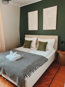 a bedroom with a large bed with green walls at Space - Style - Prime location - Old Town views in Tallinn