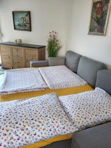 a living room with a couch with pillows on it at Apartment Mali raj in Medulin