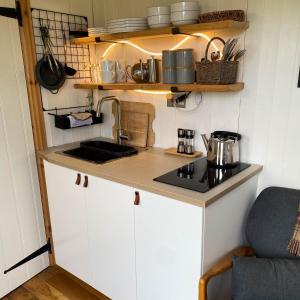 a small kitchen with a sink and a stove at Doris in Wedmore +19 photos