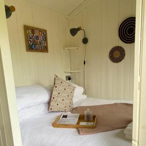 a bedroom with a bed with a book on it at Doris in Wedmore