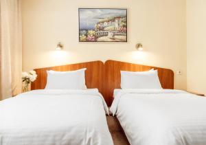 Postel nebo postele na pokoji v ubytování PecherSky Hotel
