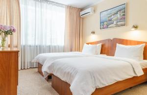 Postel nebo postele na pokoji v ubytování PecherSky Hotel