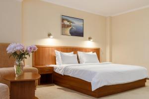 Postel nebo postele na pokoji v ubytování PecherSky Hotel