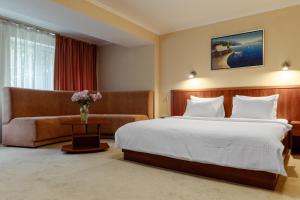 Postel nebo postele na pokoji v ubytování PecherSky Hotel