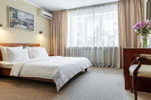 Postel nebo postele na pokoji v ubytování PecherSky Hotel