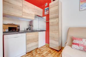 a small kitchen in a small apartment with a couch at Edelweiss in Morzine +6 photos