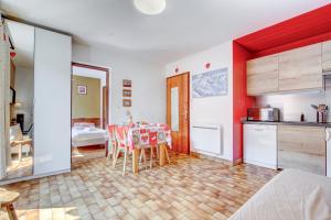 a kitchen and dining room with a table and chairs at Edelweiss in Morzine