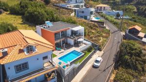 an aerial view of a house with a swimming pool at Casa Teixeira by Atlantic Holiday in Estreito da Calheta