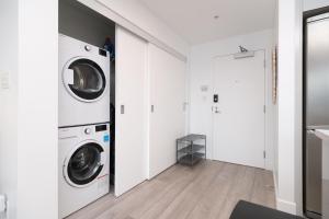 a laundry room with a washer and dryer at The Ocean Crest in Vancouver