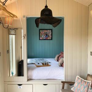 a bedroom with a bed with a mirror in it at Daphne in Wedmore