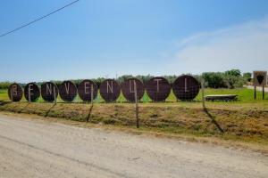 a fence with wooden signs on the side of a road at Terre Di Nacchia in Capodimonte