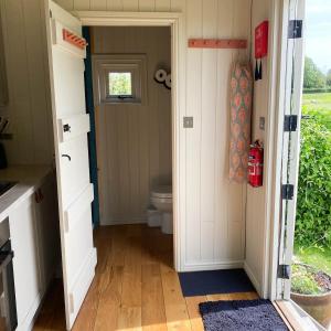 a small bathroom with a toilet and a window at Daphne in Wedmore