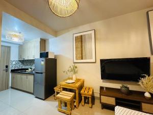 a kitchen with a small table and a refrigerator at Seaside Bliss - Wabi-sabi Home close to MOA and Airport in Manila +3 photos