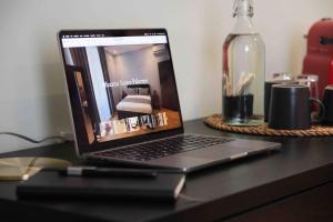 a laptop computer sitting on top of a desk at Mazzini Suites Palermo in Palermo