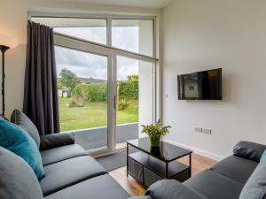 a living room with a couch and a large window at 2 Bed in Brixham 78565 in Brixham