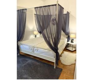 a bedroom with a canopy bed with curtains at Ferienpark im schönen Falkenstein 2 in Falkenstein +51 photos