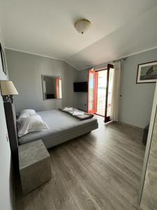 a bedroom with a bed and a large window at Apartments and Rooms Lanča in Rab