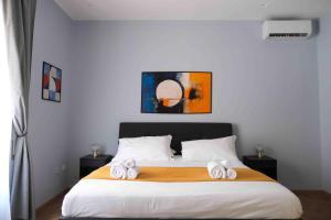a bedroom with a bed with towels on it at Mazzini Suites Palermo in Palermo