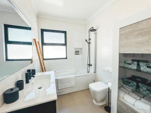 a white bathroom with a sink and a toilet at VIVA Quinta I Quinta do Ananás Pineapple Farmhouse in São Roque +30 photos