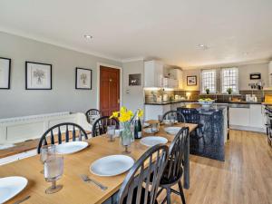 a dining room with a table and chairs and a kitchen at 4 Bed in Crosby-on-Eden 94398 in Crosby +16 photos