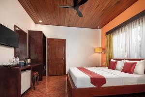 a bedroom with a bed and a ceiling fan at Lavender Angkor Boutique in Siem Reap