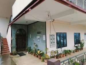 a front door of a house with potted plants at Coorg villa homestay in Madikeri