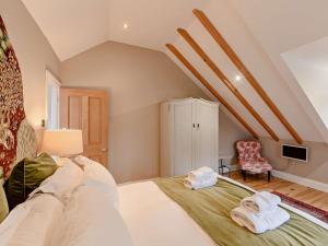 a bedroom with a bed with towels on it at 3 Bed in Harbottle 61257 in Harbottle