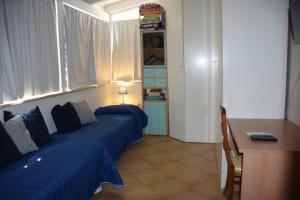 a bedroom with a blue bed with a window at Villa MEMA in Bisceglie