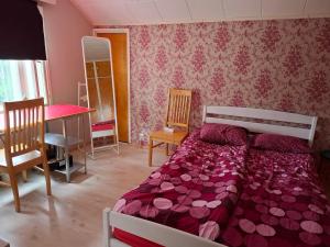 a bedroom with a bed and a table and chairs at Ahopelto in Savonlinna