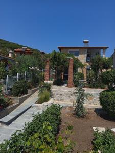 ein Haus mit einem Garten davor in der Unterkunft Blue Paradise Villa in Karianí