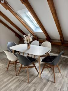 a dining room with a white table and chairs at Guesthouse Anderten in Hannover