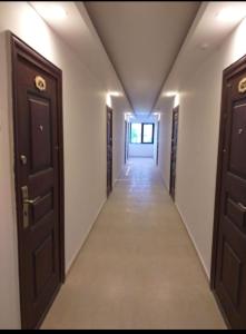 a corridor in a building with two doors at BetaBlue Apartament in Saturn