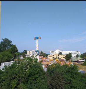a city with a ferris wheel in the background at BetaBlue Apartament in Saturn