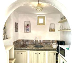 a kitchen with a sink and a counter top at Houch d exception Djerba Hood in Bin Rhilouf +11 photos